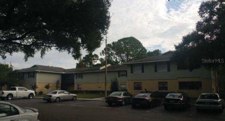 a couple of cars parked in front of a house
