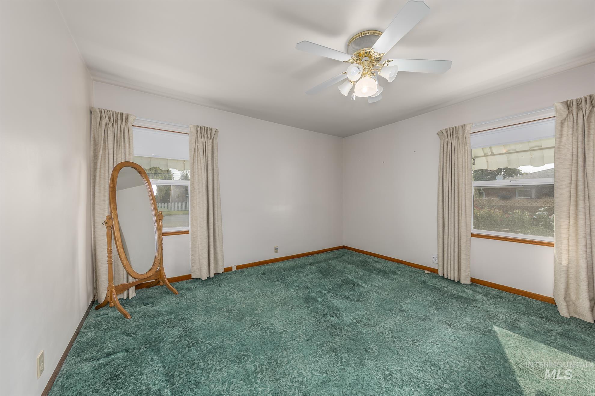 116 Pioneer Road Weiser, ID 83672 - Photo 12 of 41 Carpeted empty room featuring baseboards and a ceiling fan