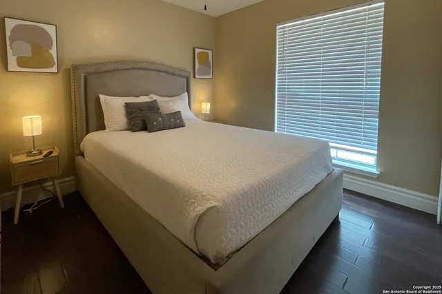 a bed sitting in a bedroom next to a window