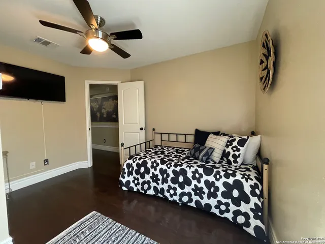 a bed room with a bed window and a flat screen tv