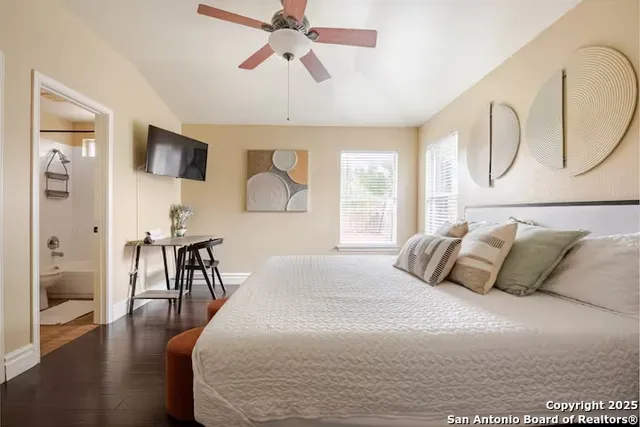 a bedroom with a large bed and a chandelier