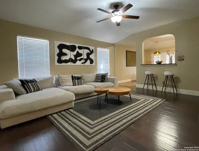 a living room with furniture and wooden floor