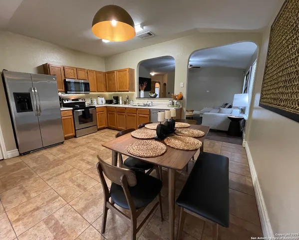 a large kitchen with a table and chairs