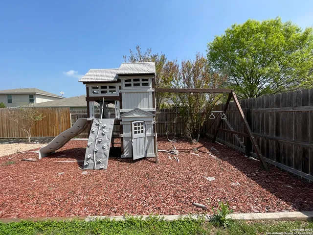 a view of a park with iron fence