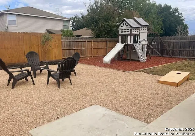 a view of a house with backyard and sitting area