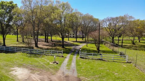 a view of a swimming pool with a yard and trees