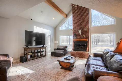a living room with furniture a ceiling fan and a window