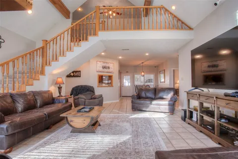 a living room with furniture a chandelier and a couch