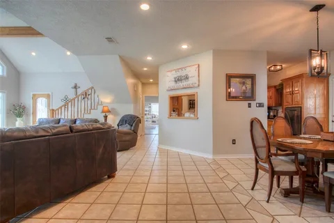 a bathroom with a granite countertop sink and a toilet