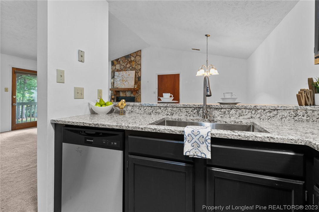 1899 Tryon Drive, Unit 8 Fayetteville, NC 28303 - Photo 14 of 25 a sink with granite countertop a sink and cabinets