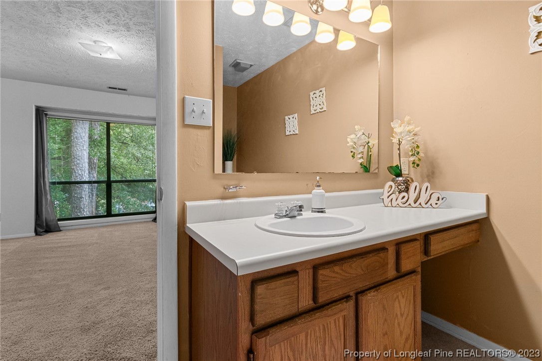 1899 Tryon Drive, Unit 8 Fayetteville, NC 28303 - Photo 21 of 25 a bathroom with a sink and a mirror