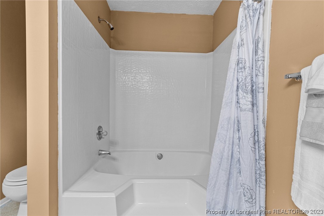 1899 Tryon Drive, Unit 8 Fayetteville, NC 28303 - Photo 22 of 25 a bathroom with a bathtub and a toilet