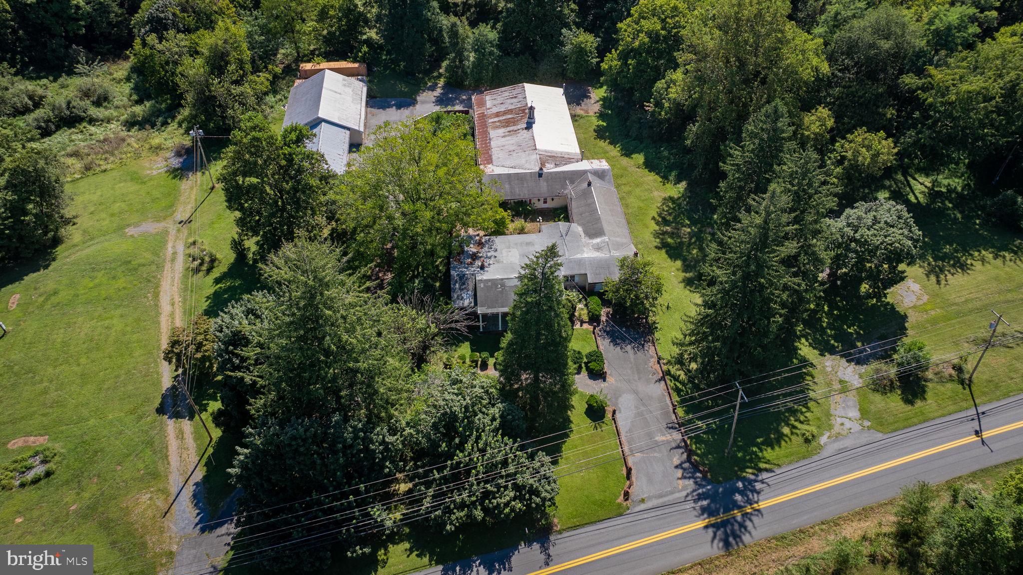 2148 Delmar Orchard Road Martinsburg, WV 25403 - Photo 4 of 22 an aerial view of a house with outdoor space and trees all around