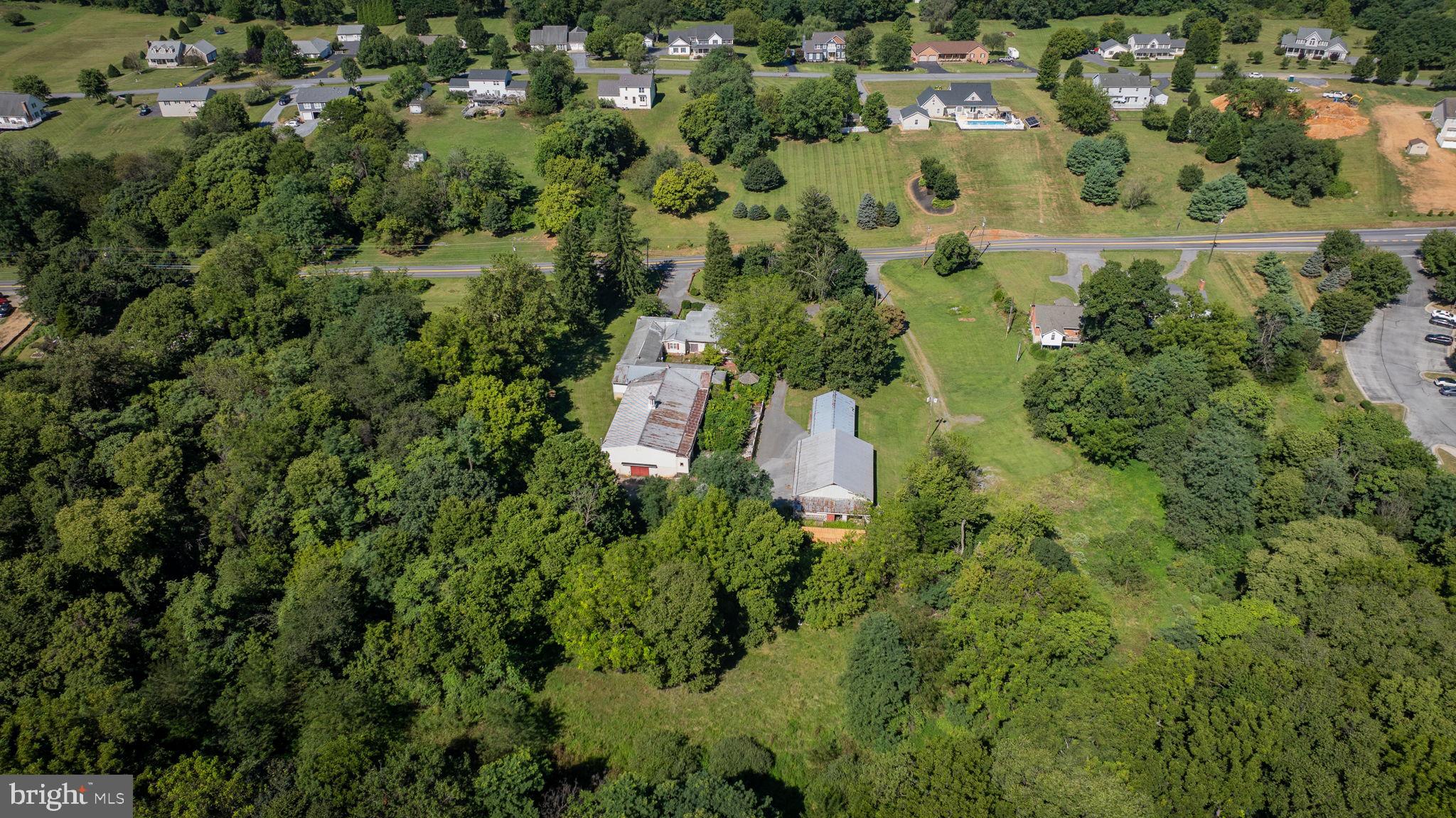 2148 Delmar Orchard Road Martinsburg, WV 25403 - Photo 8 of 22 an aerial view of residential house with outdoor space and trees all around