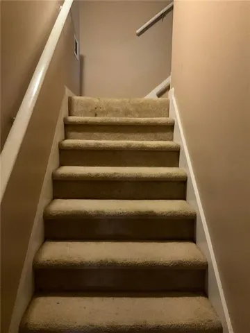 a view of staircase with white walls