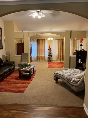 a living room with furniture and a chandelier