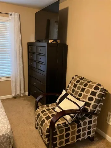 a bedroom with a bed and a mirror