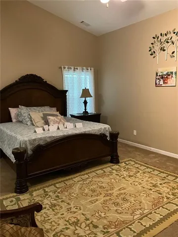 a bedroom with a bed and a chair