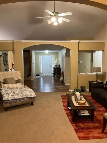 a living room with furniture and a chandelier