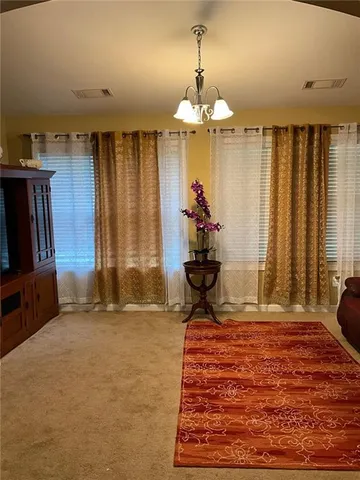 a view of a livingroom with hardwood floor and a ceiling fan