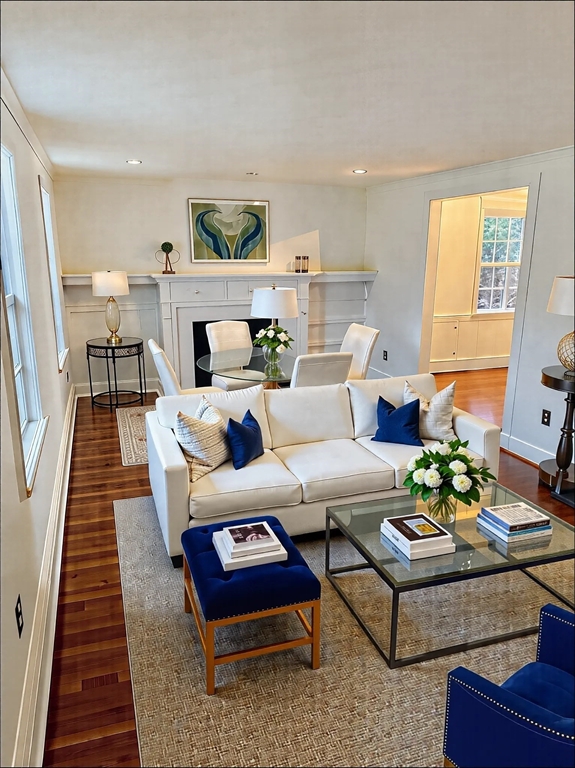 a living room with furniture fireplace and a table
