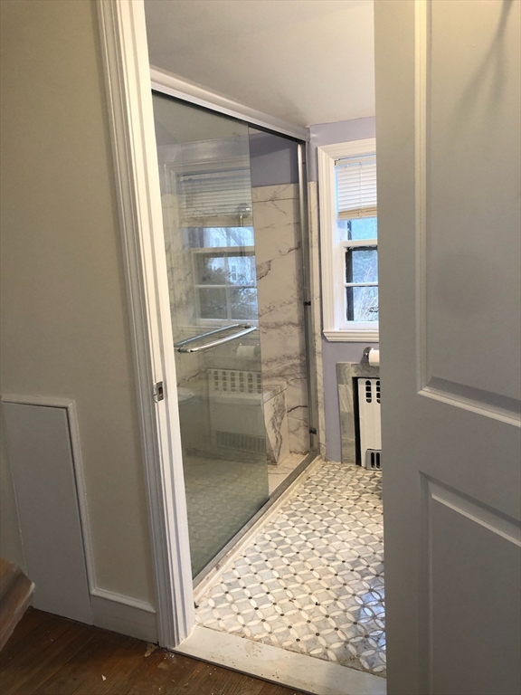 50 Colonial Road Hingham, MA 02043 - Photo 18 of 24 a bathroom with a glass shower door