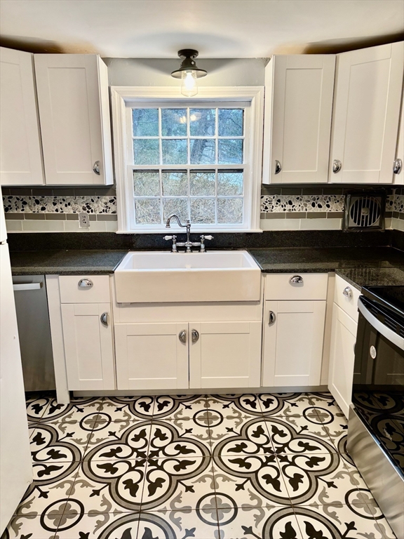 50 Colonial Road Hingham, MA 02043 - Photo 7 of 24 a kitchen with a stove and a microwave