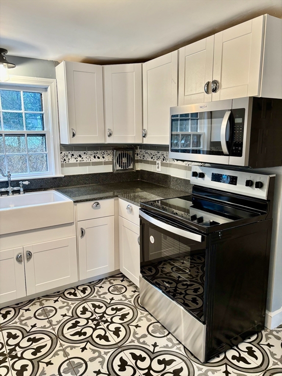 50 Colonial Road Hingham, MA 02043 - Photo 8 of 24 a kitchen with stainless steel appliances a stove a sink and a microwave