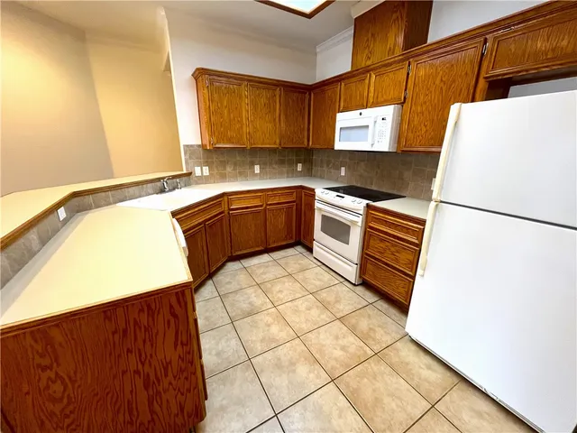 a kitchen with stainless steel appliances granite countertop a refrigerator sink and cabinets
