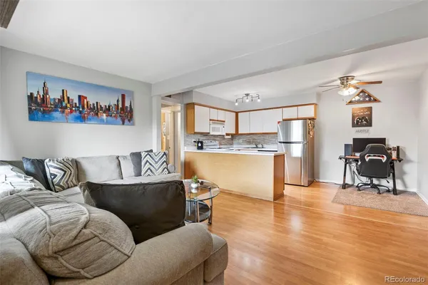 a living room with furniture and a kitchen view