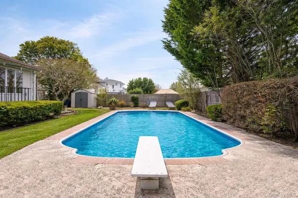 a view of a swimming pool with a yard