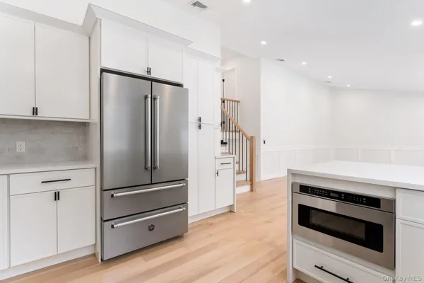 a kitchen with a refrigerator and a stove top oven