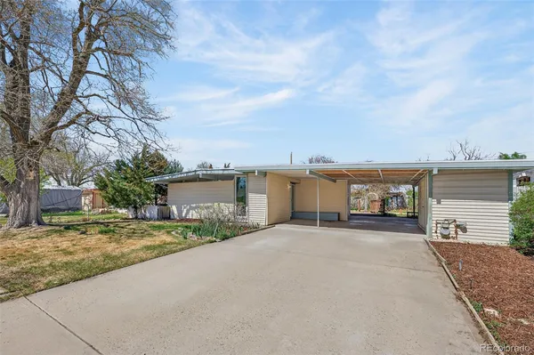 front view of a house with a yard and trees