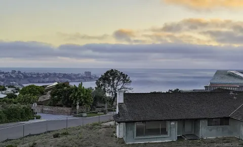 an aerial view of residential houses with city view