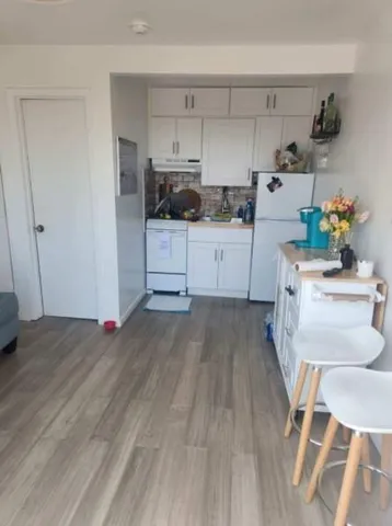 a kitchen with white cabinets and white appliances