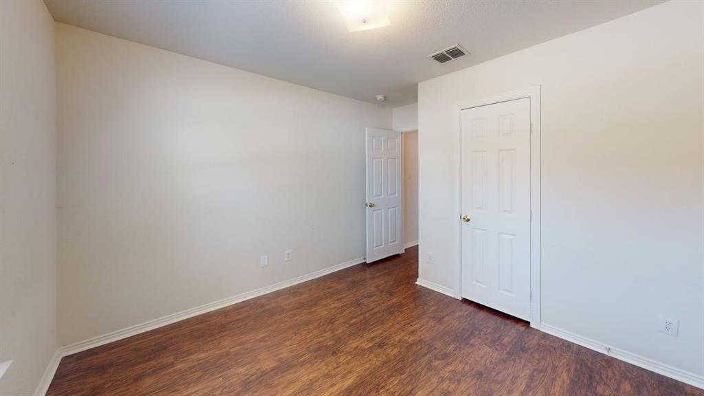3223 Winding Ridge Circle Arlington, TX 76063 - Photo 14 of 27 Empty room featuring baseboards and dark wood-style flooring