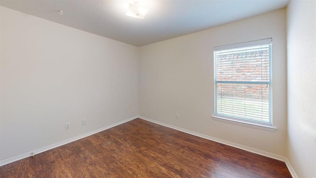 3223 Winding Ridge Circle Arlington, TX 76063 - Photo 16 of 27 Unfurnished room with dark wood-style floors and baseboards