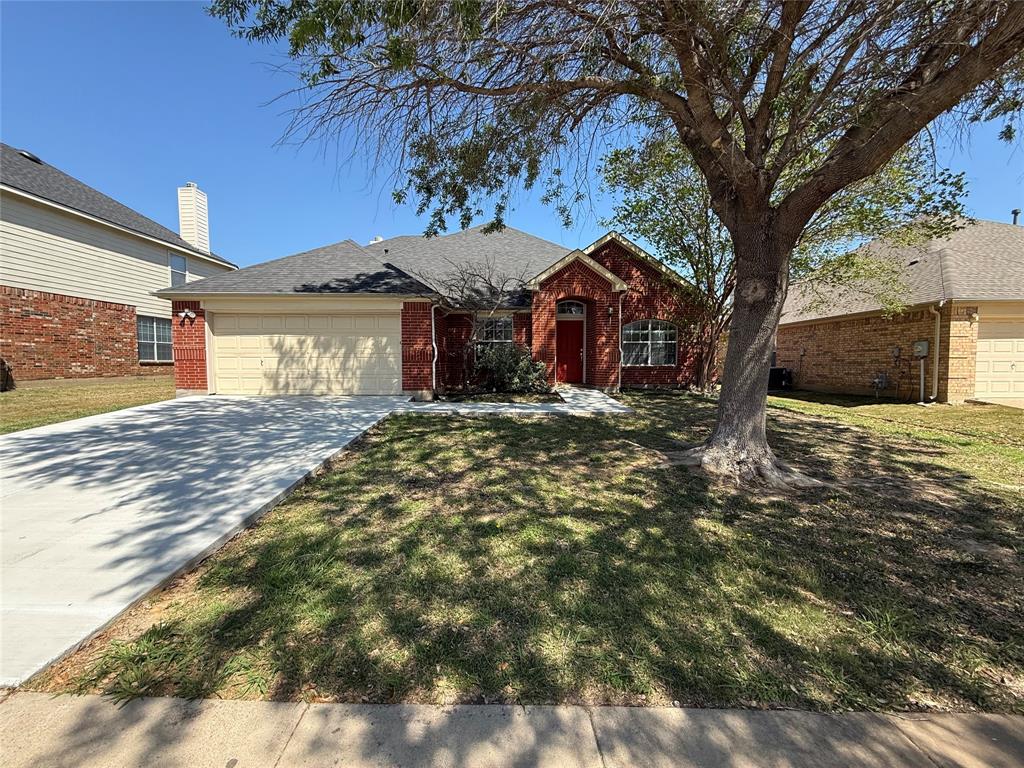 3223 Winding Ridge Circle Arlington, TX 76063 - Photo 2 of 27 Ranch-style house featuring an attached garage, driveway, brick siding, a front lawn, and a shingled roof