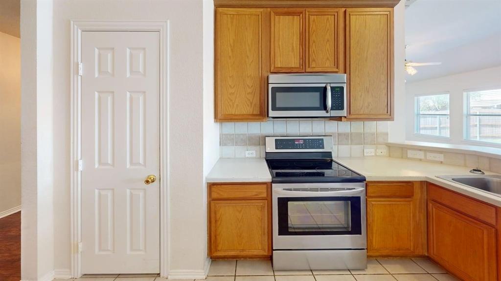 3223 Winding Ridge Circle Arlington, TX 76063 - Photo 5 of 27 Kitchen featuring stainless steel appliances, light countertops, tasteful backsplash, wood finish cabinets, and ceiling fan