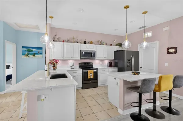 a kitchen that has a table chairs and a refrigerator