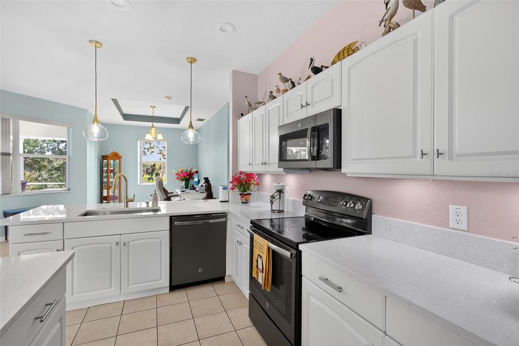 145 Brig Circle East Placida, FL 33946 - Photo 20 of 44 a kitchen with a sink stove and microwave