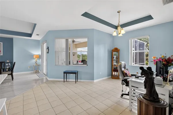 a view of a livingroom with furniture and a kitchen