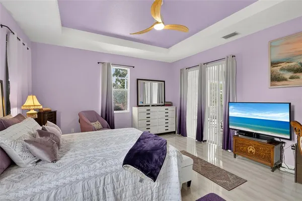 a bedroom with a bed and a tv on the dresser