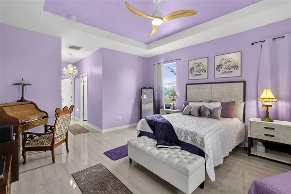 a bedroom with a bed couch and dresser