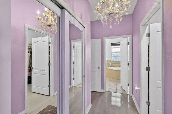 a spacious bathroom with a tub sink and mirror