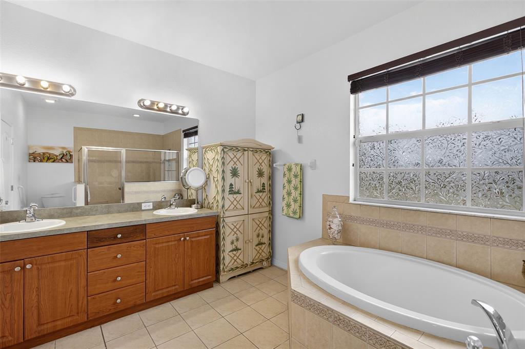 145 Brig Circle East Placida, FL 33946 - Photo 31 of 44 a spacious bathroom with a granite countertop tub sink and mirror