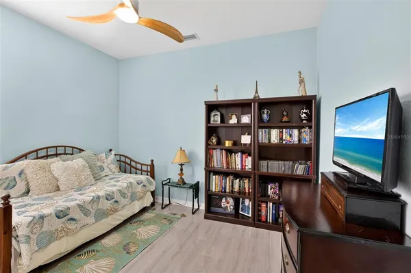 a bedroom with a bed and a lamp