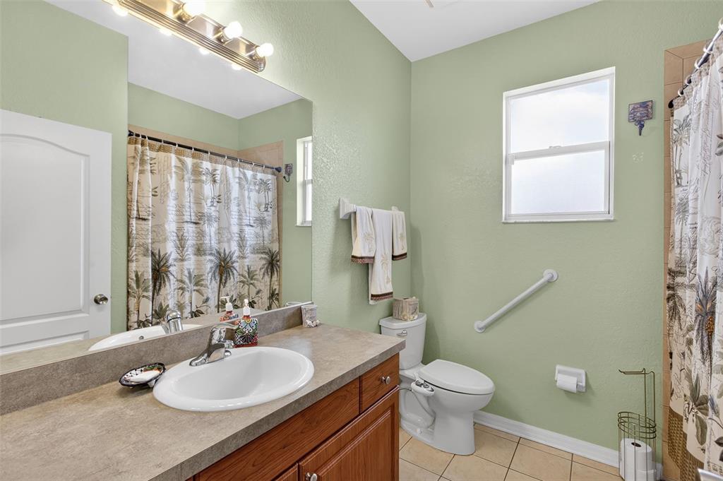 145 Brig Circle East Placida, FL 33946 - Photo 35 of 44 a bathroom with a granite countertop sink toilet a large mirror and shower