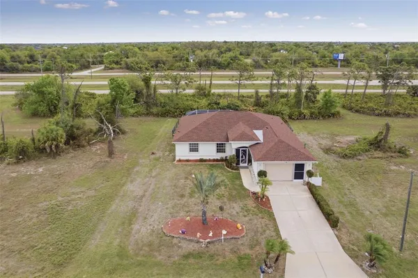 an aerial view of a house with a lake view