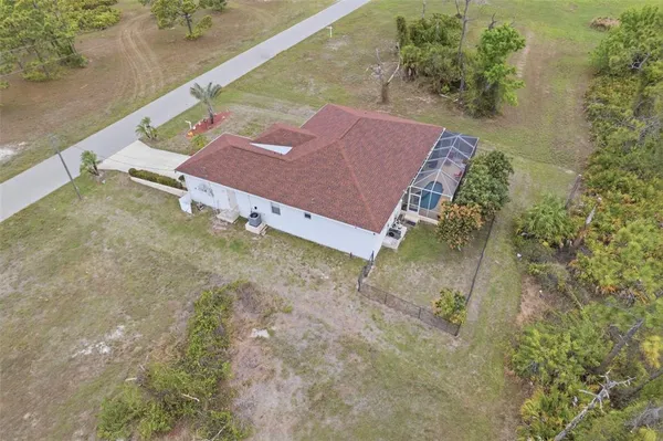 an aerial view of a house with a yard